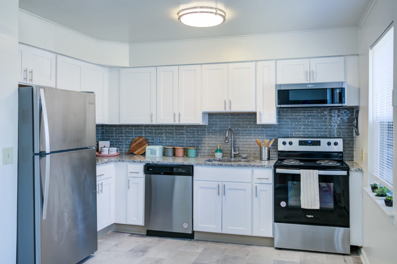 Kitchen with white cabinetry with stainless-steel appliances at Eatoncrest Apartment Homes in Eatontown, New Jersey