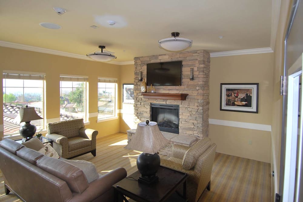 Fireside seating in the entertainment room at Brightwater Senior Living of Highland in Highland, California