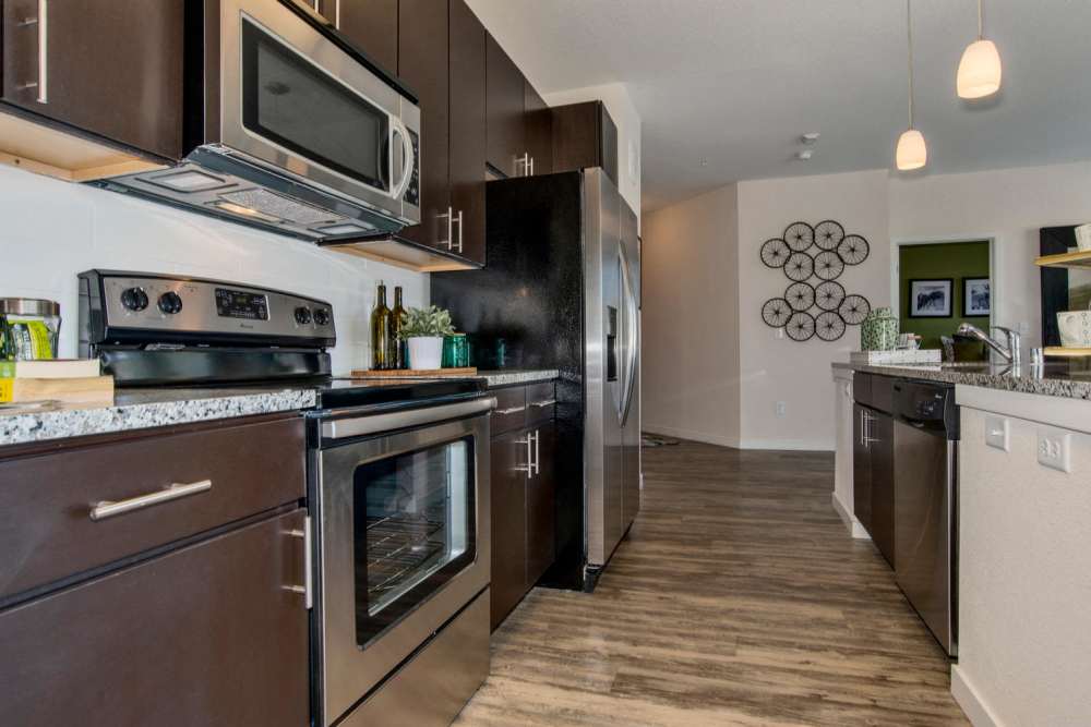 Kitchen with stainless-steel appliances at Westlink at Oak Station Apartments in Lakewood, Colorado