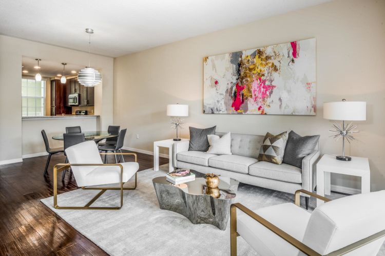 Well-decorated living space in an open-concept model senior apartment at Riverwalk Pointe in Jupiter, Florida