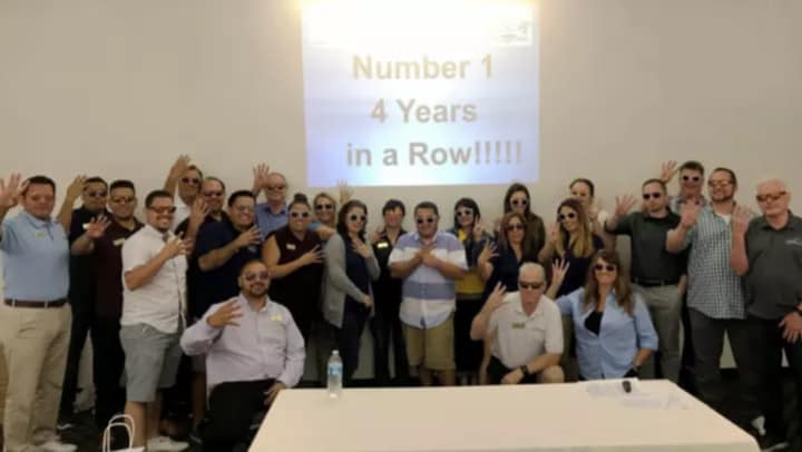SDSS managers posing with 4 fingers up to represent 4 straight years!
