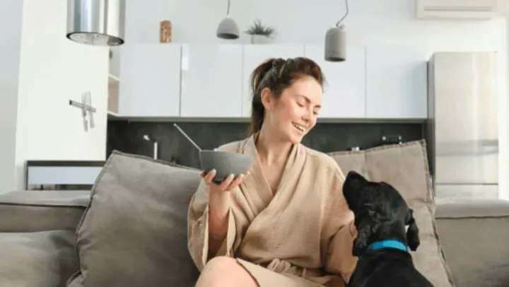 Resident with her pet in a living room