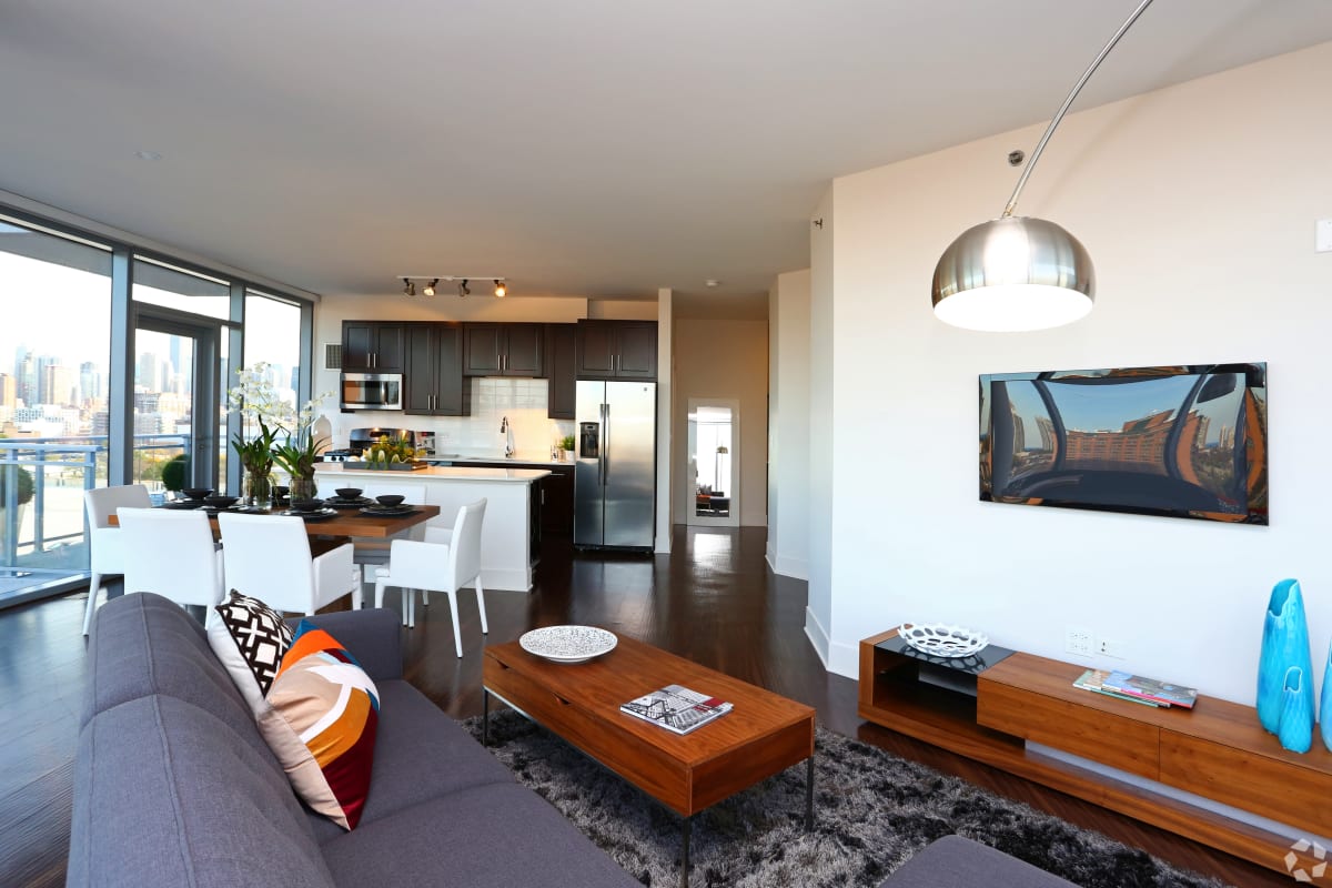 Spacious living room with a windowed wall at The Residences at NEWCITY in Chicago, Illinois