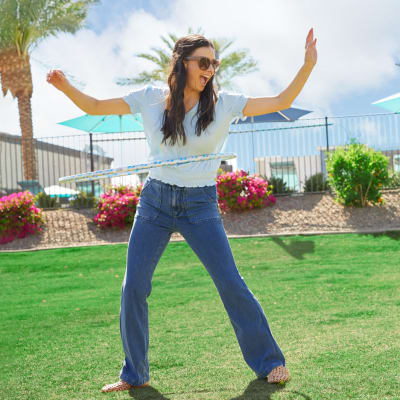Residents hula hooping in the grass outside on a sunny day at BB Living in Scottsdale, Arizona