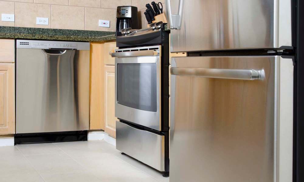 Kitchen with a dishwasher and a refrigerator at MeadowView Townhomes in Goshen, Ohio