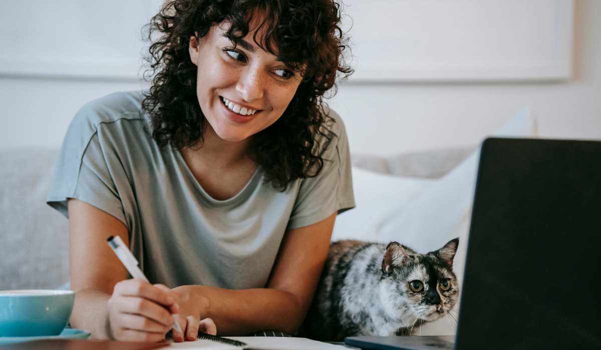 Reisdent with her cat working in laptop at Sullivan in Austin, Texas