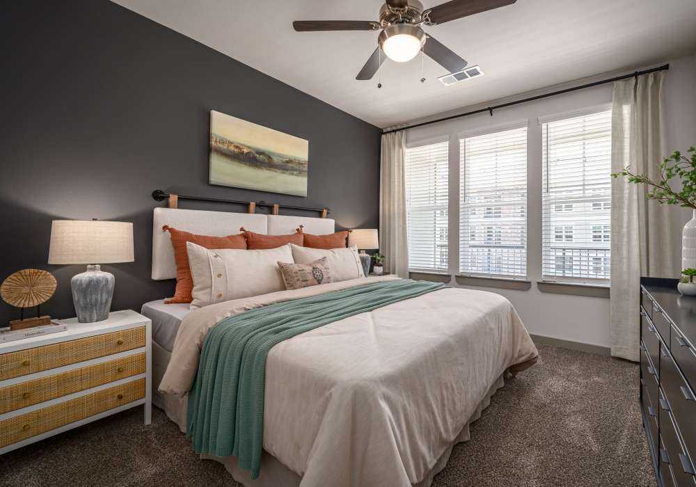 Bed in a furnished bedroom at Charleston at Fannin Station in Houston, Texas
