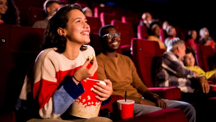 Friends enjoying a comedy movie at the cinema | movie theaters in Fort Worth