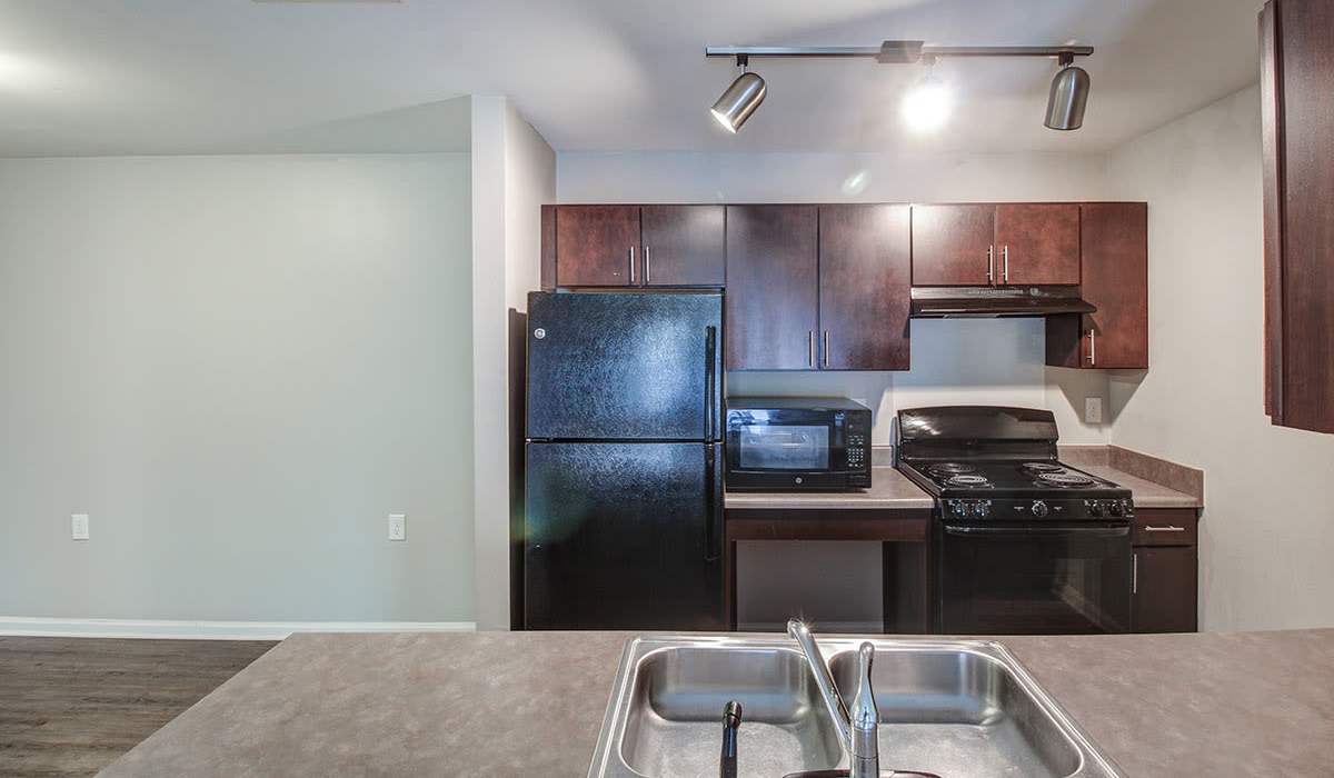 A kitchen with black features at Northside Drive Apartments in Crossville, Tennessee