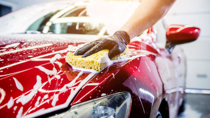 a red car gets a hand wash | car washes near charlotte