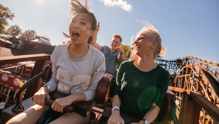 A group of young people smiling on ride at an amusement park around Odessa