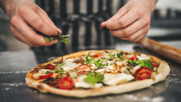 Chef preparing a Neopolitan-style pizza