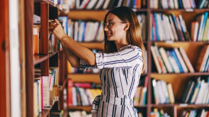 Woman flipping through a book in Santa Fe bookstores