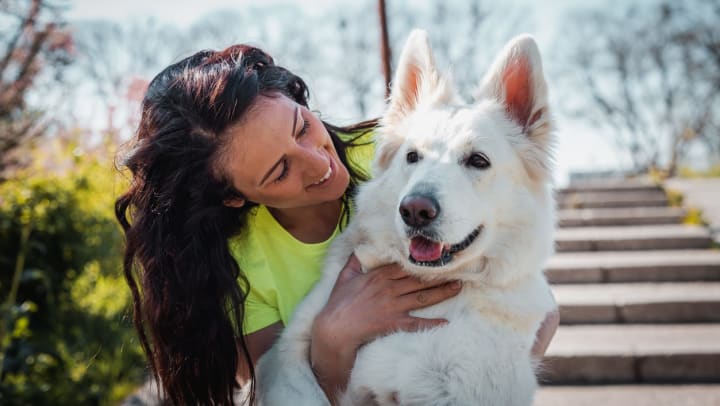 woman smiling with dog outside | dog parks in Santa Fe