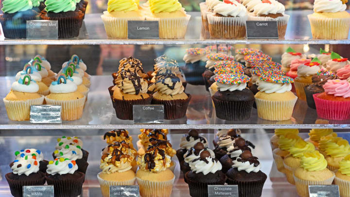  An assortment of cupcakes on display in a bakery