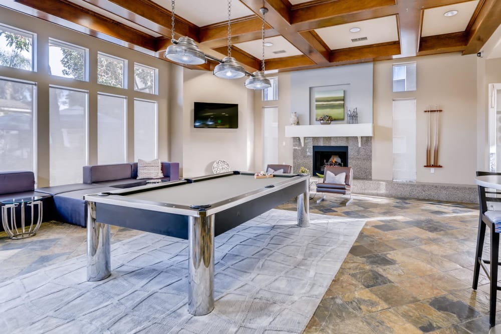 Interior view of the resident clubhouse with a billiards table at Alize at Aliso Viejo Apartment Homes in Aliso Viejo, California