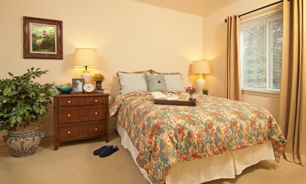 Spacious bedroom with a large window at Patriots Glen in Bellevue, Washington. 