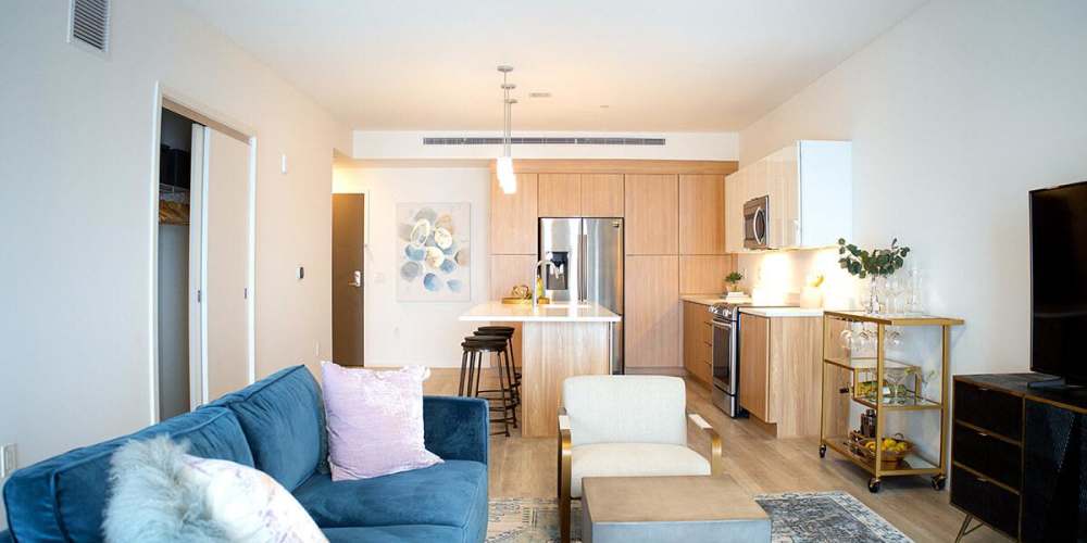 A furnished living room and kitchen in a model apartment at The Beacon in Cleveland, Ohio