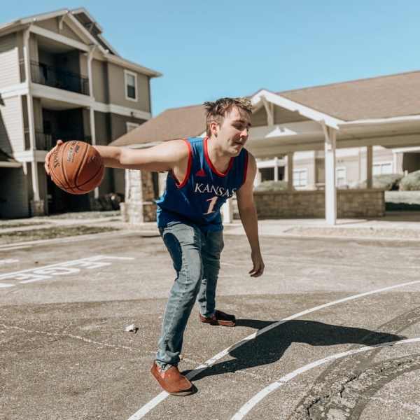 Resident playing basketball at The Quarters at Lawrence in Lawrence, Kansas