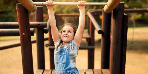 A child on the jungle gym near Pinecrest Apartments in Fallbrook, California