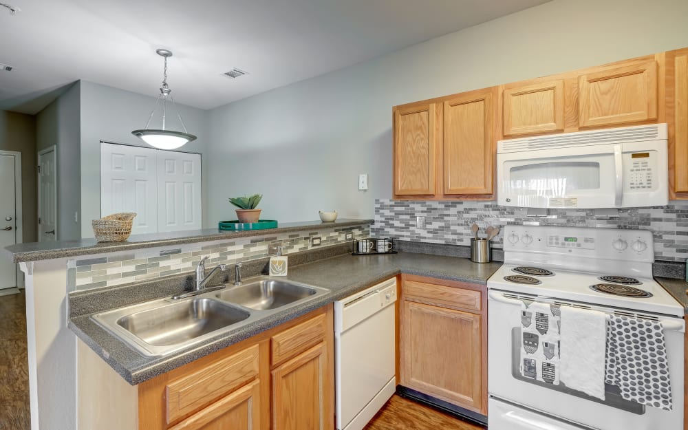 Kitchen with white appliances at Crescent at Wolfchase in Memphis, Tennessee