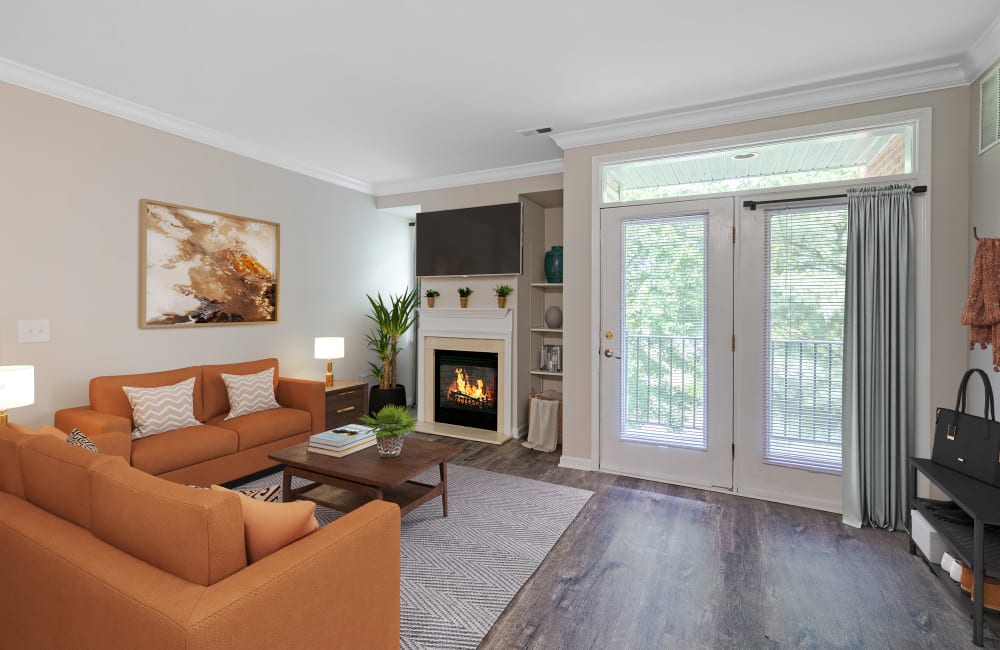 Living room with vinyl plank floors and a fireplace at Bishop's View Apartments & Townhomes in Cherry Hill, New Jersey