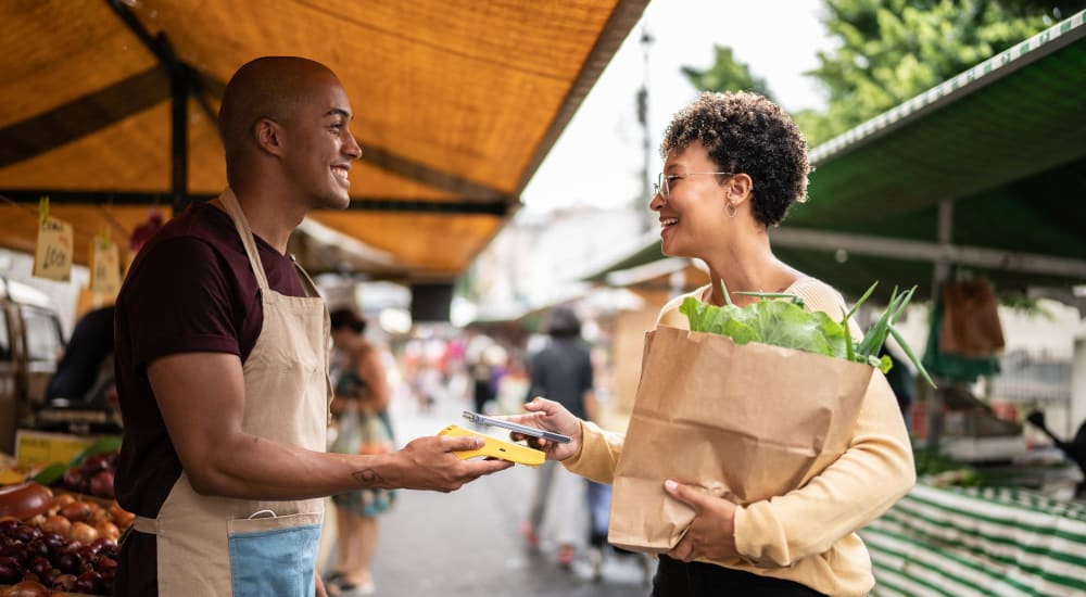 Resident shopping at a farmer's market near The Quarry Apartments in La Mesa, California