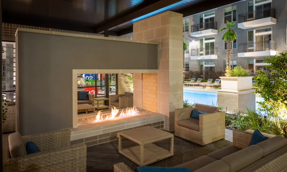 Fireplace seating by the pool at Bellrock Summer Street in Houston, Texas