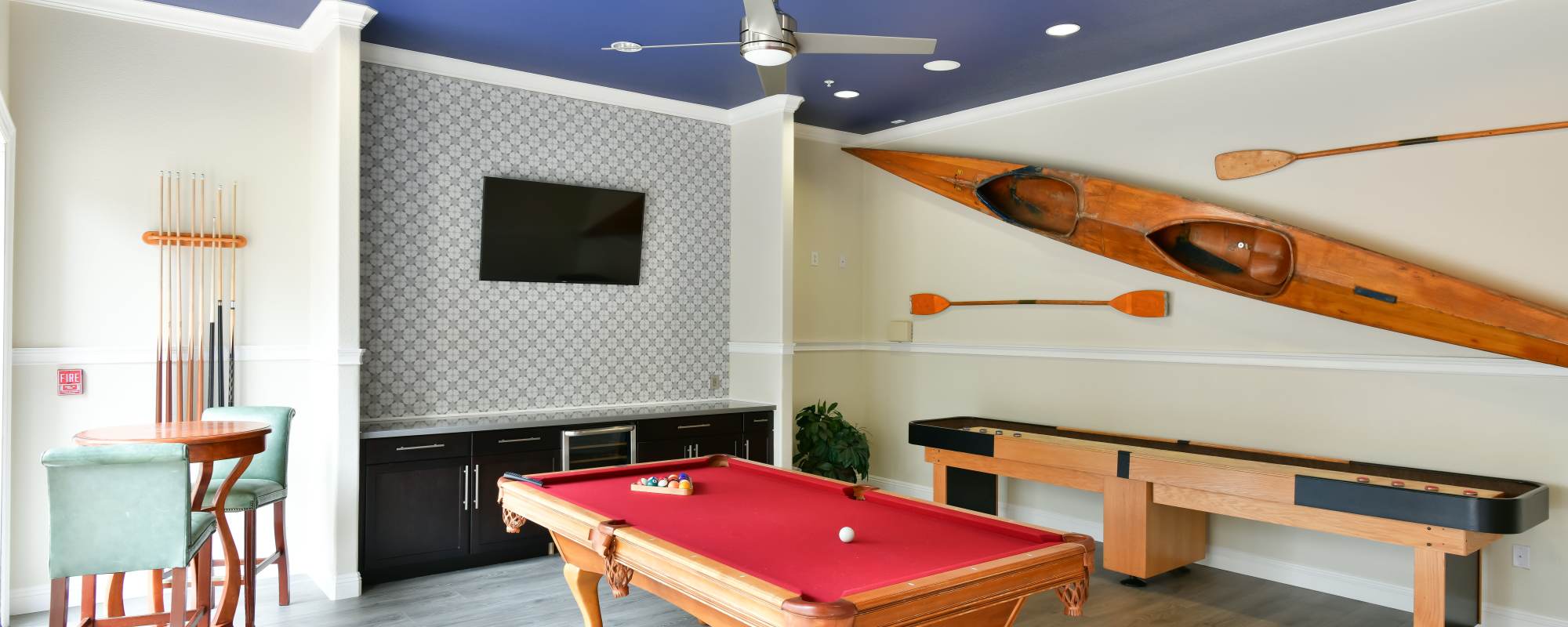 Game room with billiards and shuffle board.