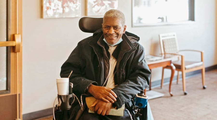 Happy resident smiling for a photo at Cascade Park Vista Assisted Living in Tacoma, Washington