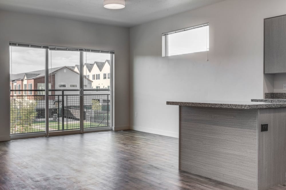 Open-living room with a large sliding glass down out to the balcony at Hawthorne Townhomes in South Salt Lake, Utah