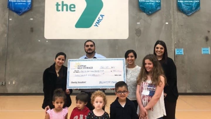 Otay Crossing manager presenting check to Border View Family YMCA