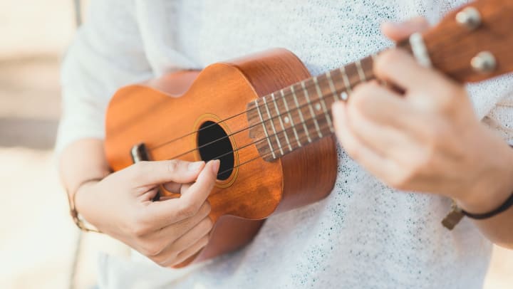 Woman playing a ukulele.