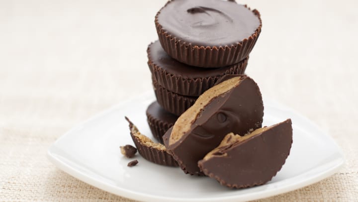 A stack of peanut butter cups on a plate.