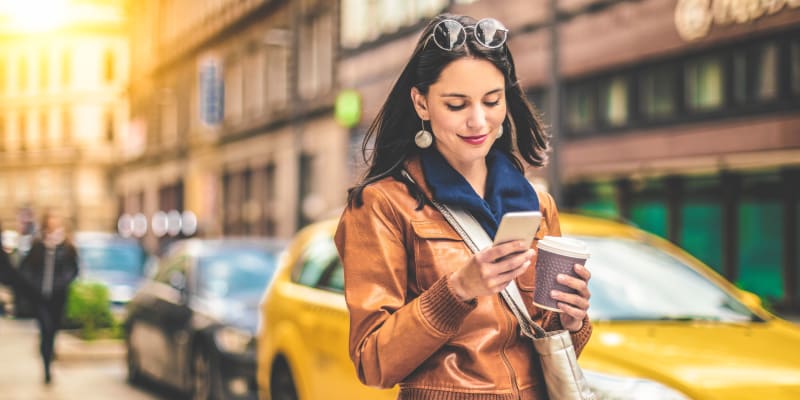A resident reviewing her phone and shopping near Adobe Flats IV in Twentynine Palms, California