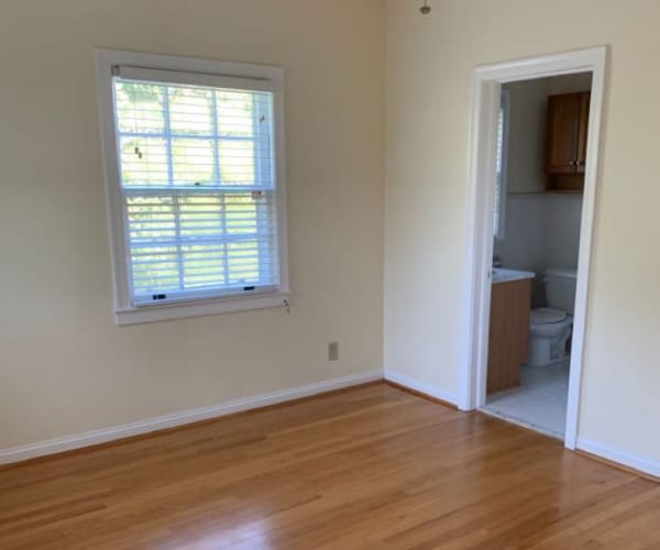 A room with wood flooring and a bathroom in a home at Breezy Point in Norfolk, Virginia