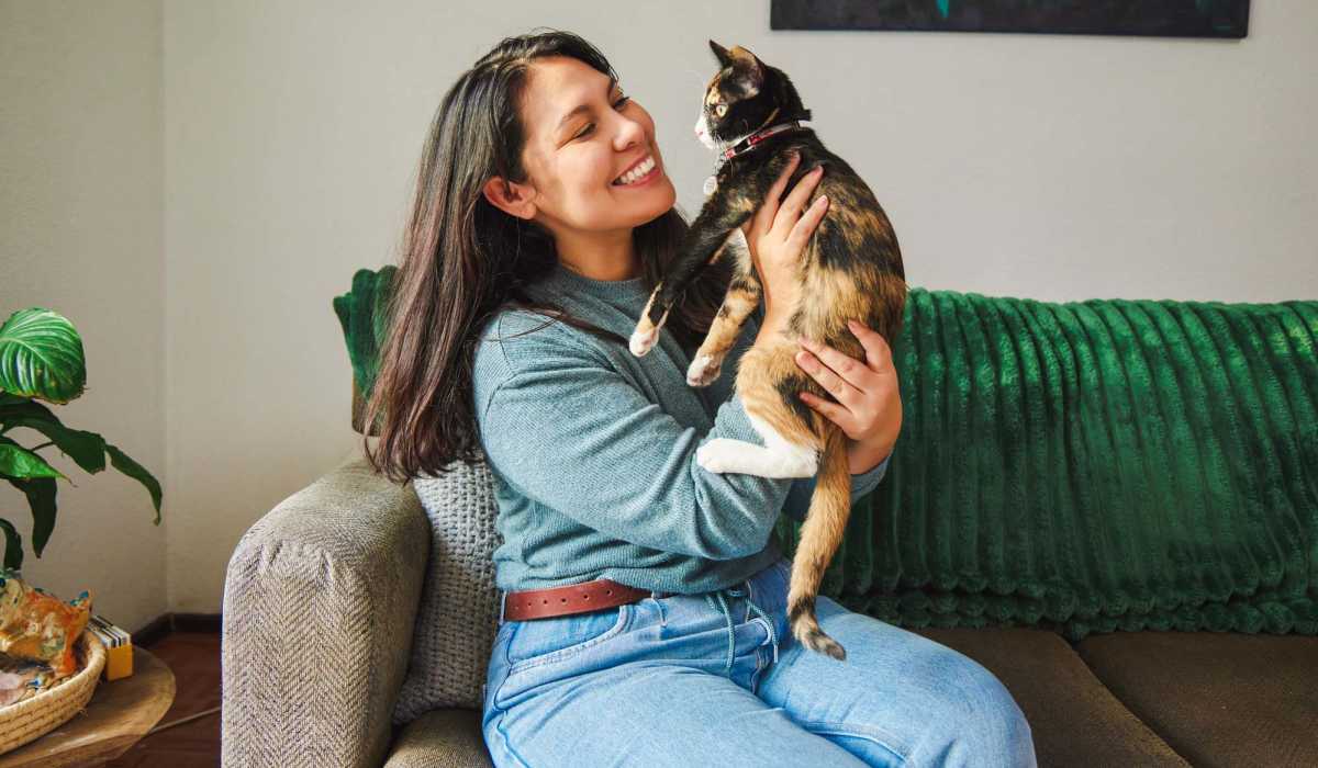 Resident with her cat in a living room at Thickett in Mt Pleasant, South Carolina