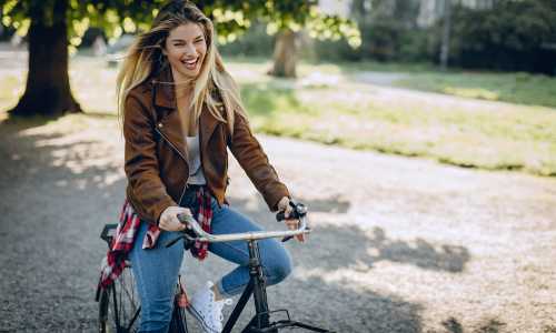Resident woman riding bicycle outside at Vivo Living Summerville in Summerville, South Carolina