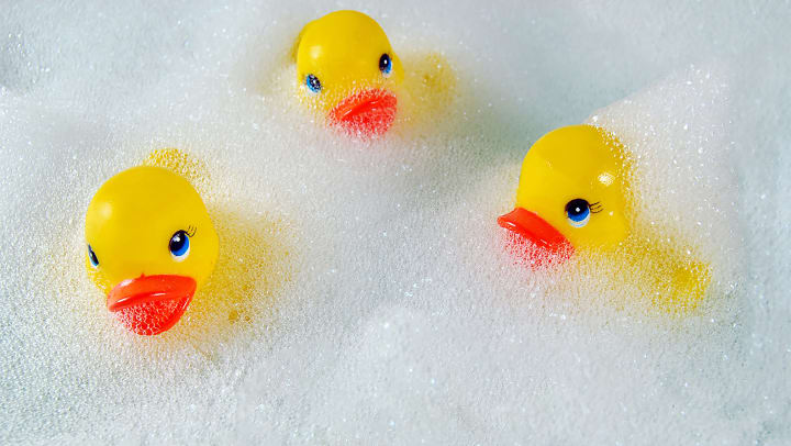 3 yellow rubber duckies in bubbles