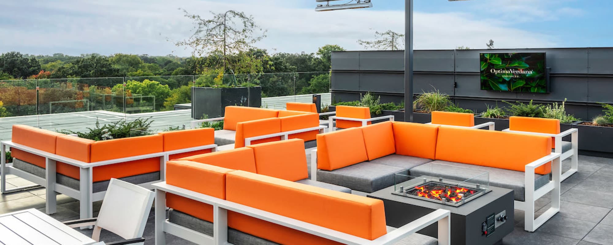 Deck top seating with orange chairs at Optima Verdana® in Wilmette, Illinois