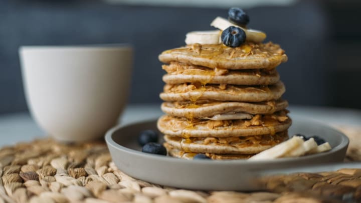 A stack of pancakes with bananas and blueberries | pancakes in Katy