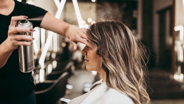 A woman with long, brunette hair at a beauty salon getting her hair done. | Hair Salons in Durango