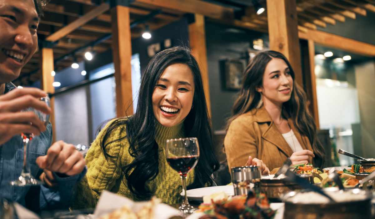 A group of friends out for a meal in a restaurant near Landmark at Marshall Broad in Richmond, Virginia