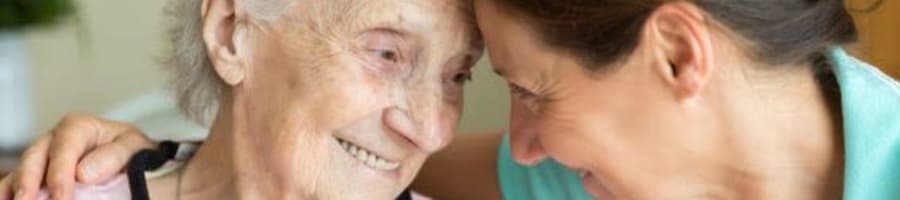 Resident smiling at a caregiver at Bell Tower Residence Assisted Living in Merrill, Wisconsin