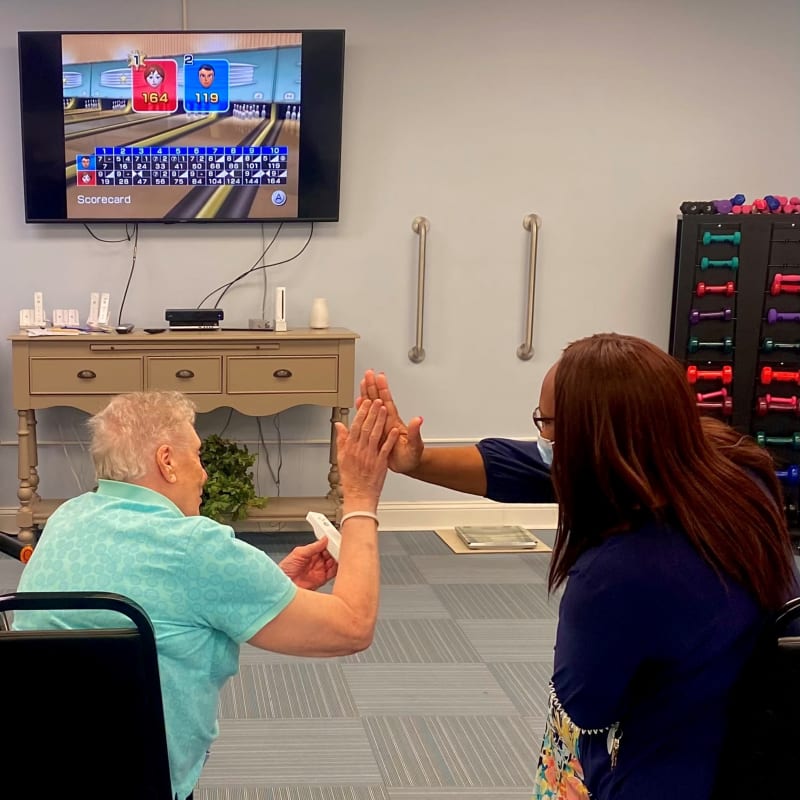 Resident playing wii with a caretaker at The Clinton Presbyterian Community in Clinton, South Carolina
