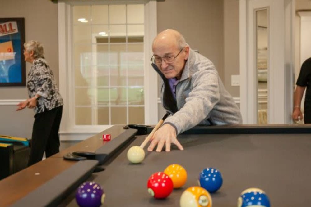 Resident playing pool at The Pinnacle at Plymouth Meeting in Plymouth Meeting, Pennsylvania