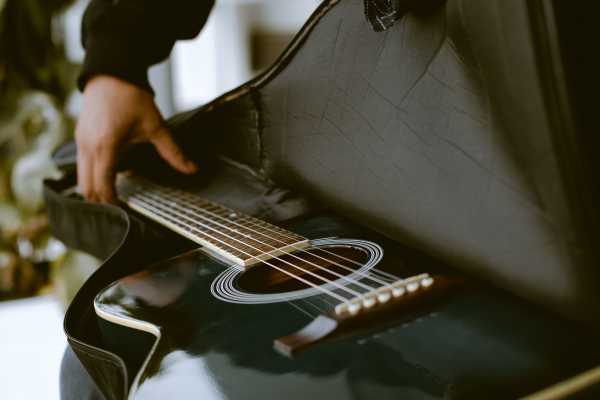 Man storing a guitar