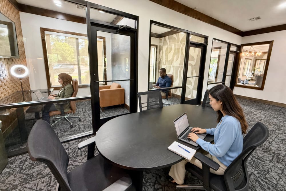Residents using the micro offices at The Abbey at Preserve Way in Tomball, Texas