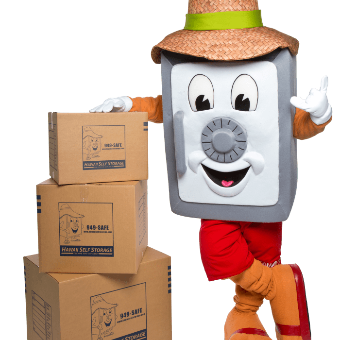 Mr. Safety posing with moving boxes, which can be purchased in the office at any Hawai'i Self Storage location