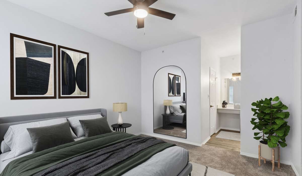 Master bedroom with king size bed, ceiling fan, full size mirror and attached bathroom at 530 Buckingham in Richardson,Texas